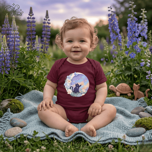 Baby wearing a Starlight Wishes Baby Moon Bodysuit sitting on a blanket in a flower garden.