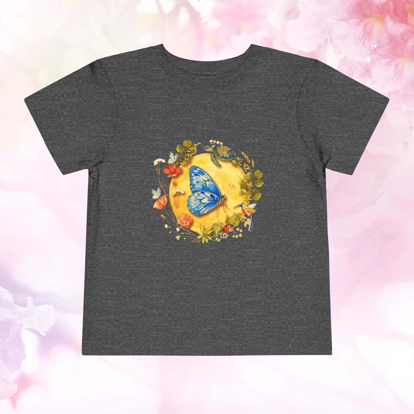 Radiant Blue Butterfly Toddler T-Shirt featuring a blue butterfly and floral designs on a dark shirt.