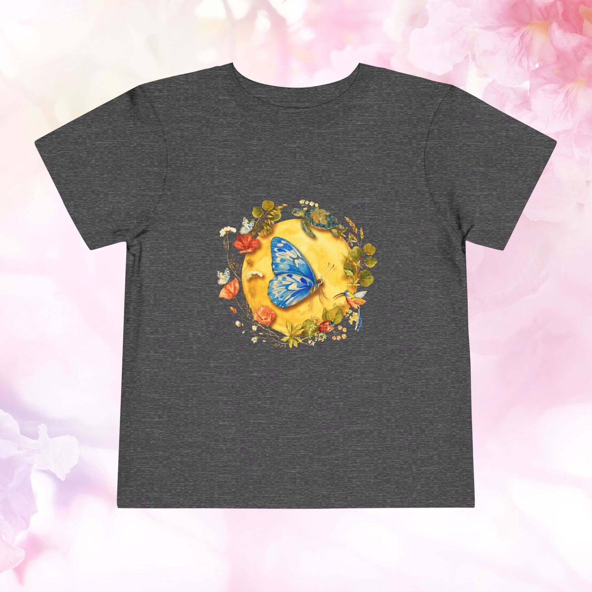 Radiant Blue Butterfly Toddler T-Shirt featuring a blue butterfly and floral designs on a dark shirt.