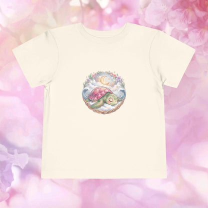 Starlit Slumber Toddler T-Shirt featuring a sleepy sea turtle under a crescent moon and clouds.