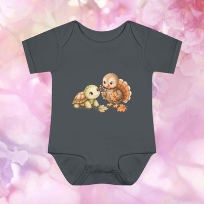 Dark heather Harvest Friends Infant Bodysuit featuring the turtle and turkey harvest artwork with warm seasonal details.