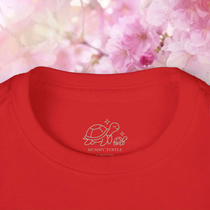 Toddler flamingo long sleeve shirt with Mummy Turtle logo on red fabric surrounded by cherry blossom flowers.