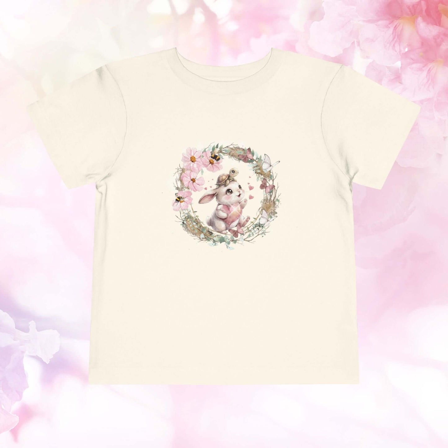 Toddler bunny t-shirt featuring a cute watercolor bunny surrounded by flowers on a soft background.