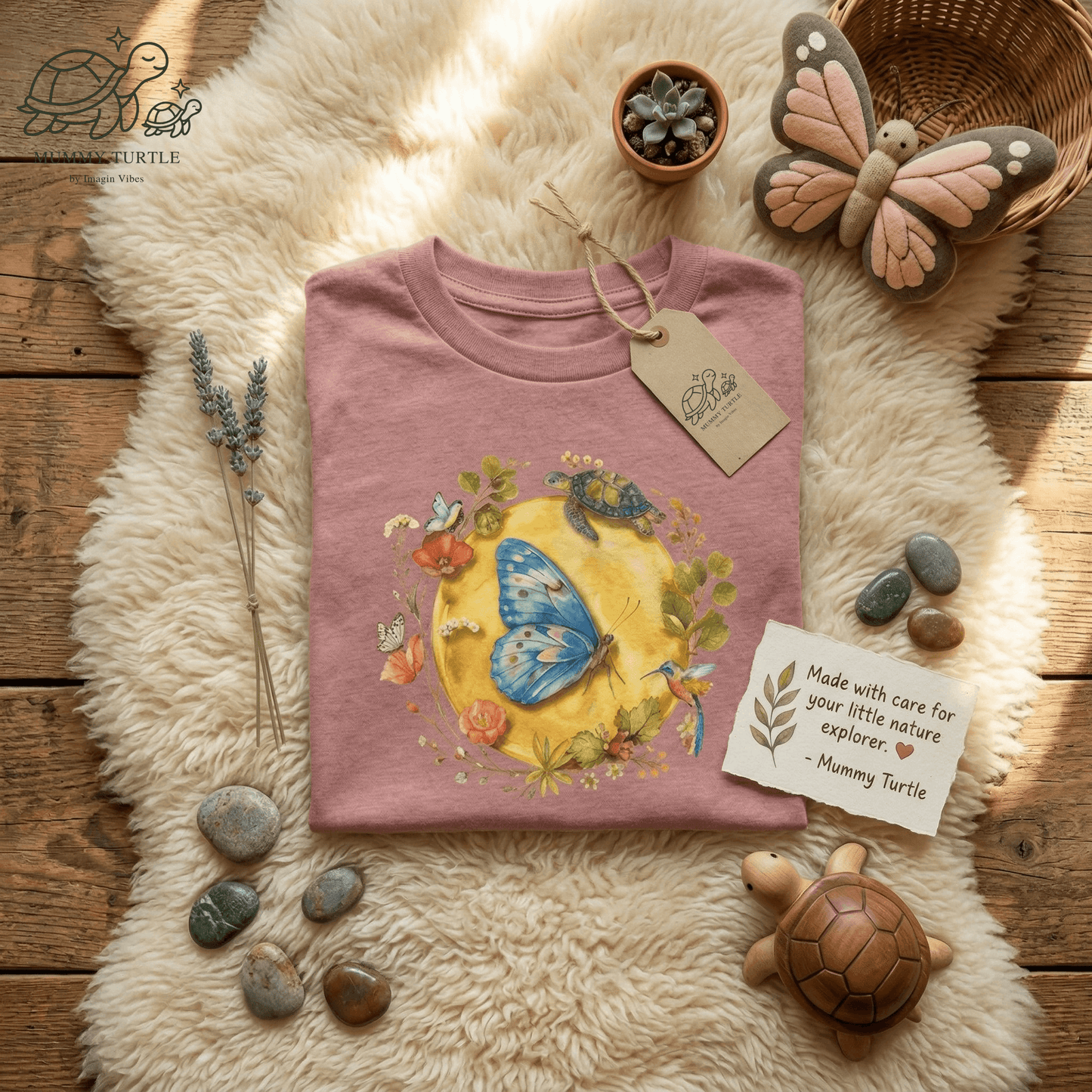 Radiant Blue Butterfly Toddler T-Shirt featuring a blue butterfly and turtle design on a soft pink backdrop.
