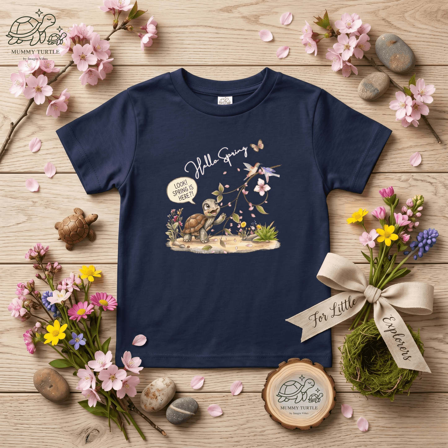 Toddler spring shirt featuring a turtle discovering spring flowers and petals on a dark blue background.