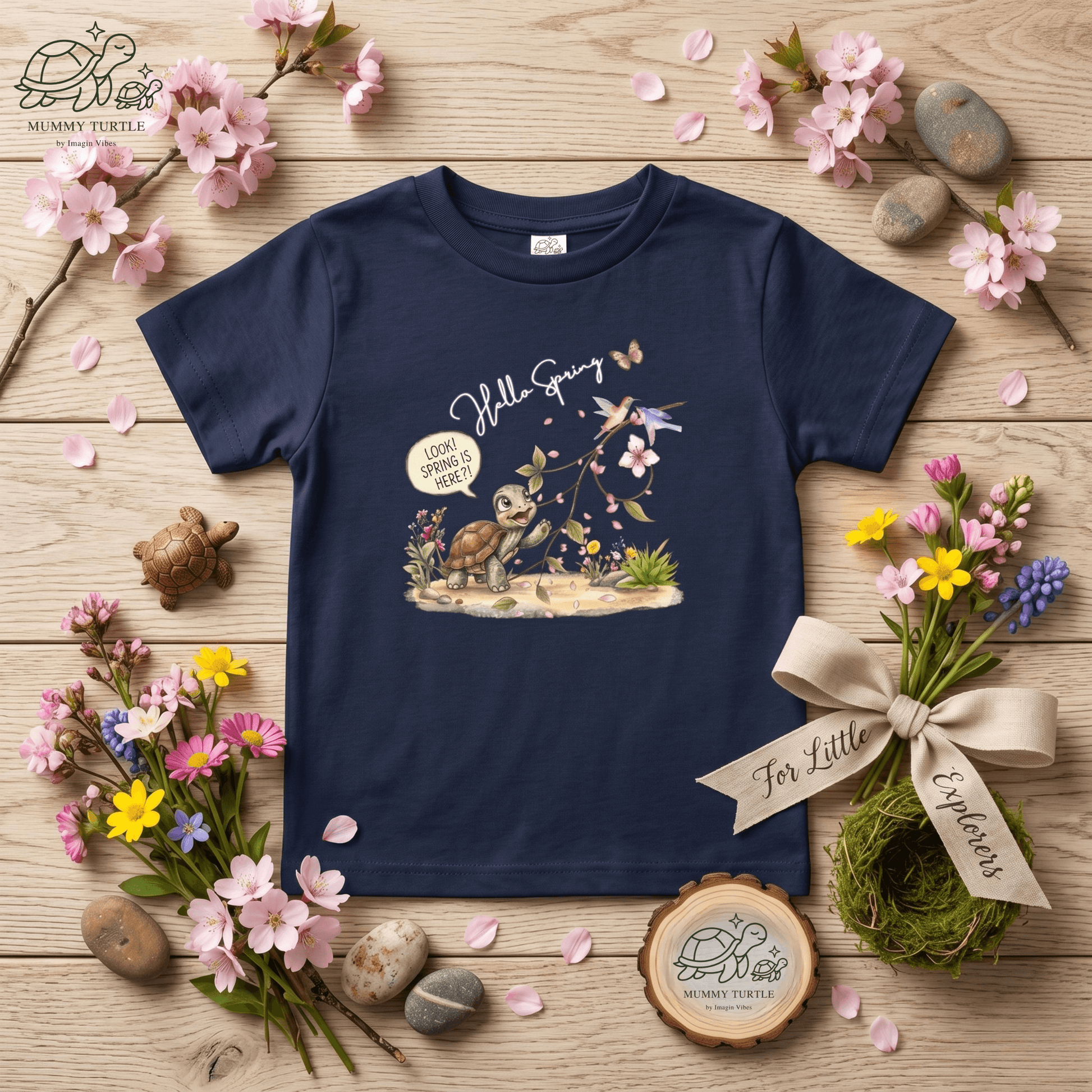 Toddler spring shirt featuring a turtle discovering spring flowers and petals on a dark blue background.