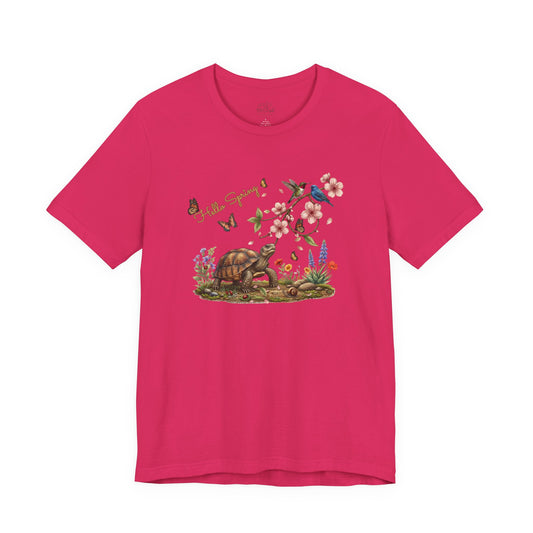 Hello Spring jersey tee featuring a turtle, pink blossoms, and colorful birds in a vibrant design.