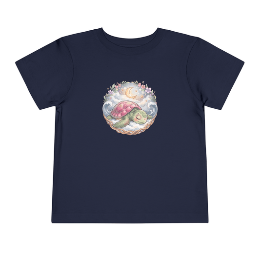 Starlit Slumber Toddler T-Shirt featuring a sleepy sea turtle design amidst clouds and a crescent moon.