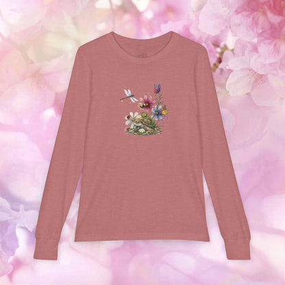 Kids blossom long sleeve shirt featuring a floral design with a turtle and butterflies on a pink background.