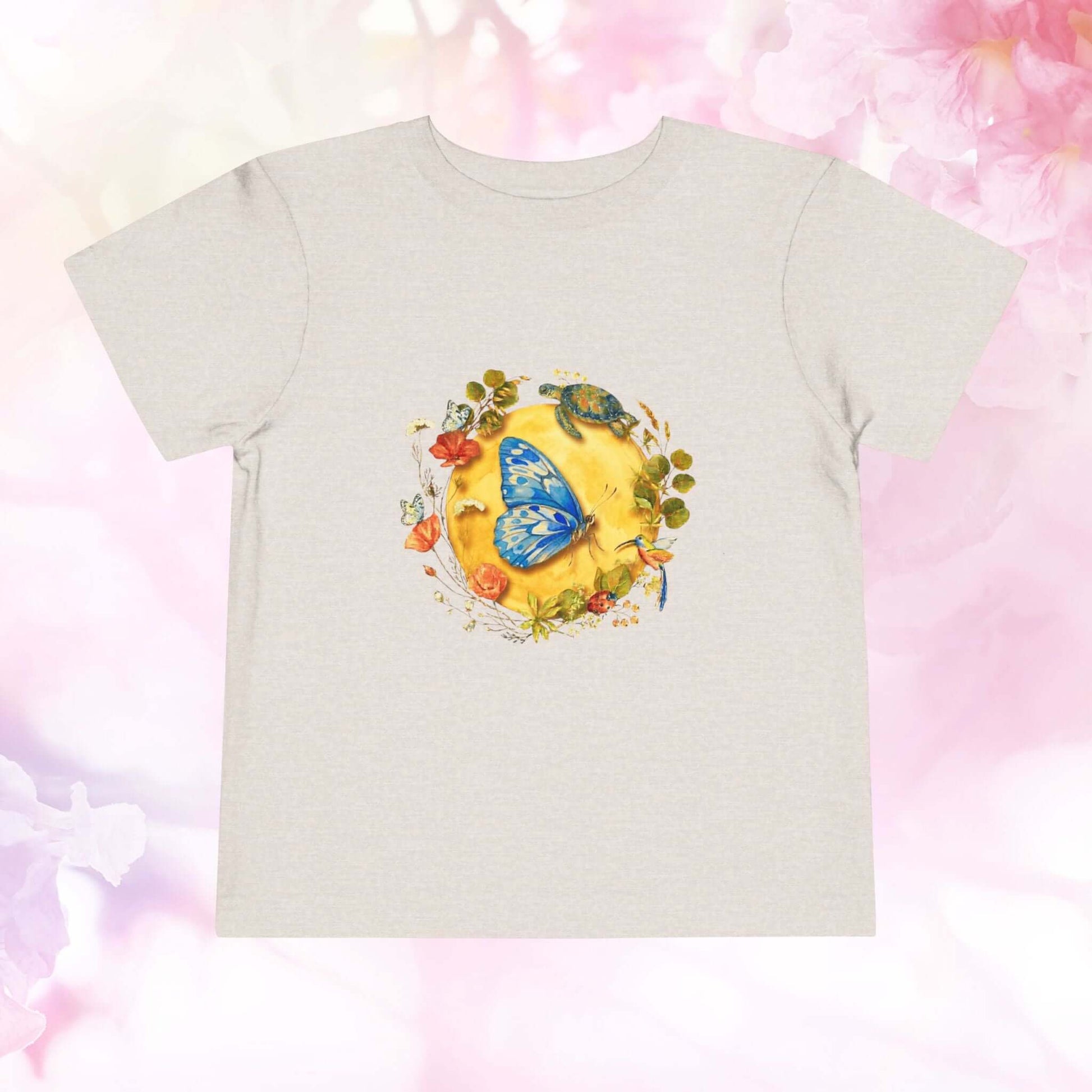 Radiant Blue Butterfly Toddler T-Shirt featuring a blue butterfly on a sunny background, perfect for little adventurers.