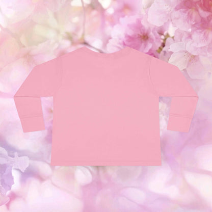 Back view of a pink toddler bunny long sleeve shirt with a soft floral background.